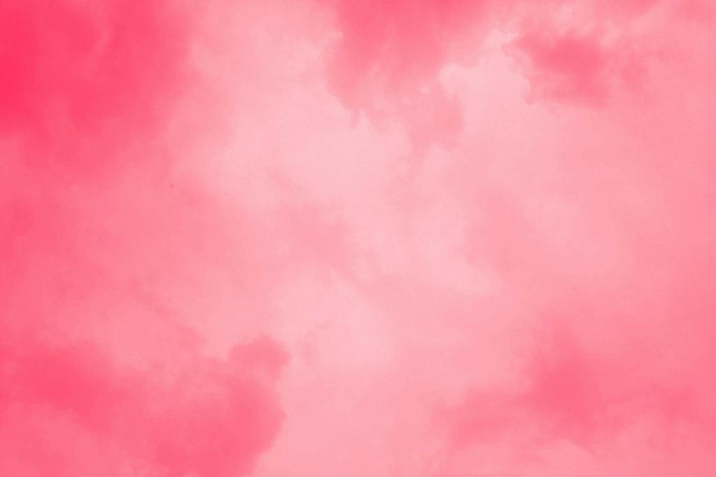 Pink-hued clouds fill the sky, creating a soft, dreamy atmosphere.